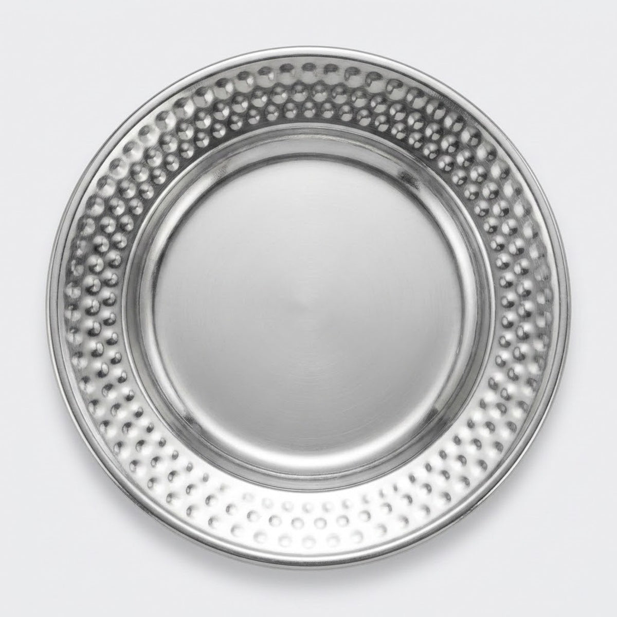 A round silver metal plate with a smooth center and a raised rim covered in a dense pattern of small raised dots, shown from a top-down view on a light gray background.