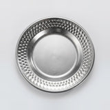 A round silver metal plate with a textured, dimpled border and a smooth, reflective center, shown from a top-down perspective on a light gray background.