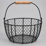 Black Wire Basket with Wood Handle shown empty against a soft gray studio background.