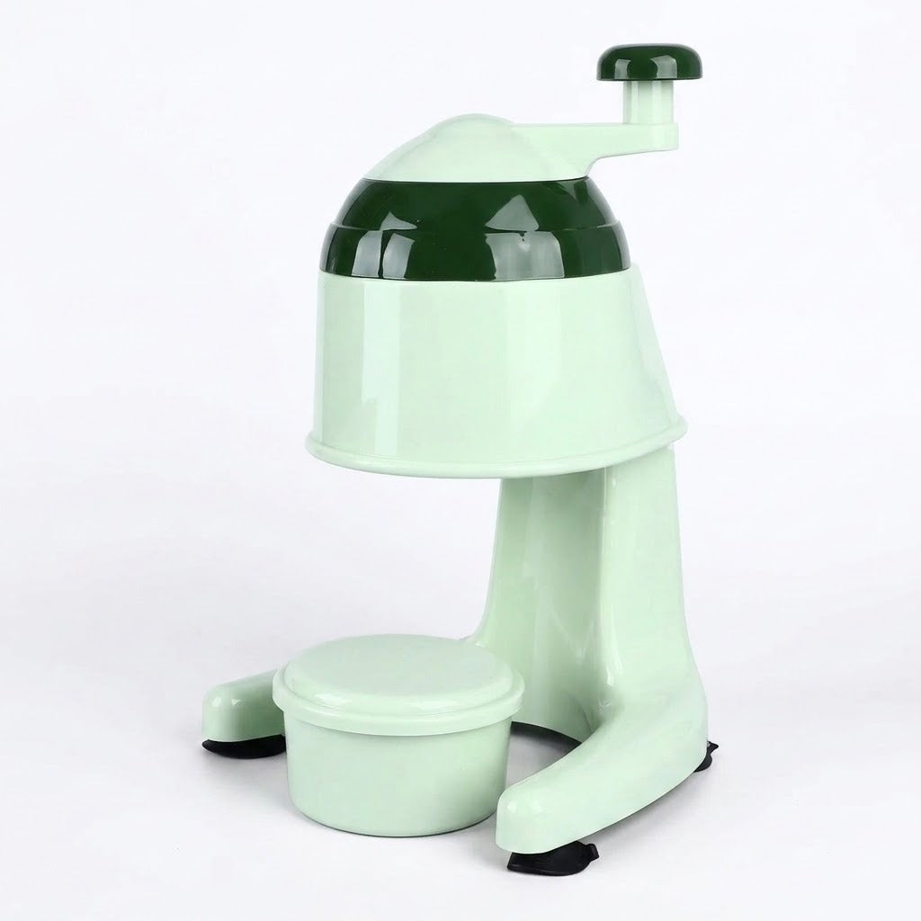 A retro-style mint green ice shaver or ice crusher with a dark green top band, a hand crank handle, and a small collection bowl, shown on a white background.