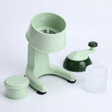 A mint green manual ice crusher set with a main crushing base, a separate dark green and mint handle, a small mint green storage container, and a clear ice bucket, shown on a white background.