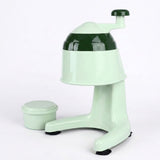 A retro-style mint green and dark green manual ice shaver with a matching small storage container, photographed on a seamless white background.