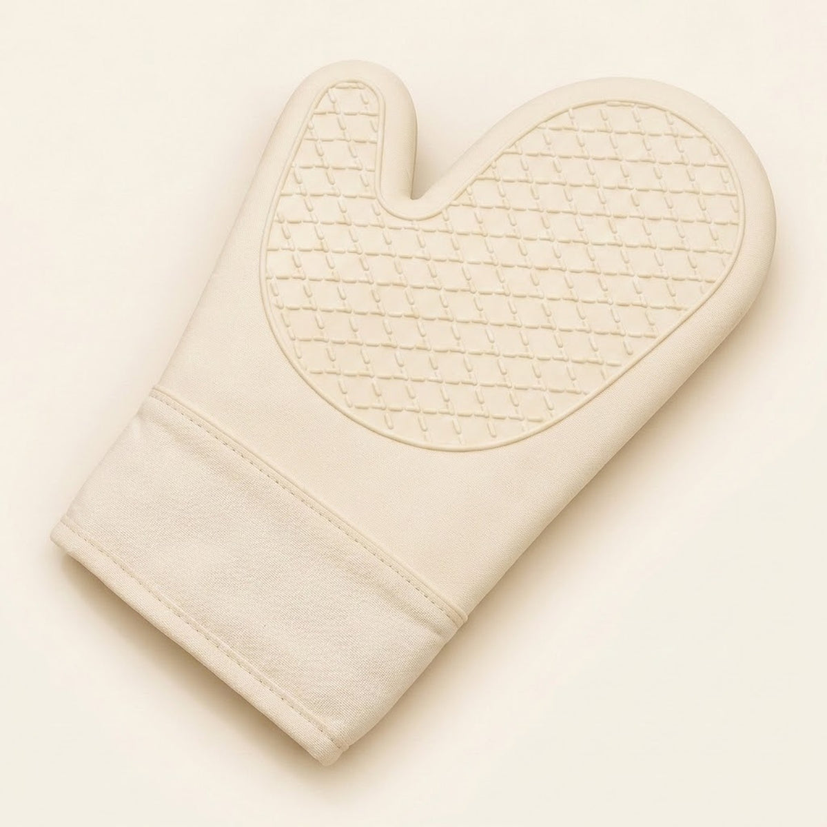 An off-white oven mitt with a quilted diamond pattern on the palm side, shown on a matching off-white background.