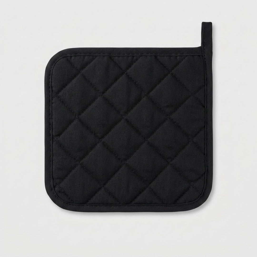 A black quilted pot holder with a diamond pattern and a loop handle, shown on a light gray background.