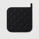 A black quilted pot holder with a diamond pattern and a loop handle, shown on a light gray background.