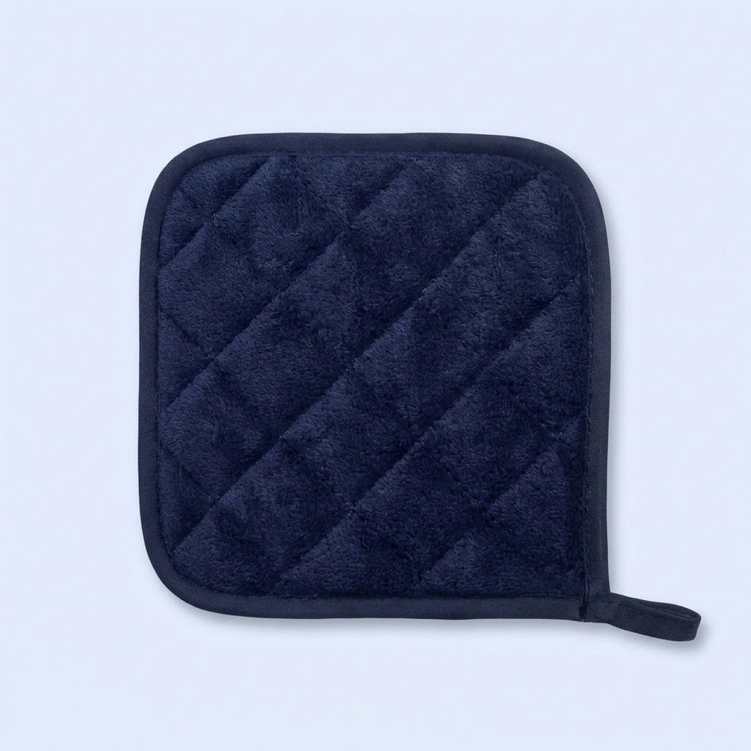 A dark navy blue quilted pot holder with a small loop on the bottom right, shown on a light blue background.