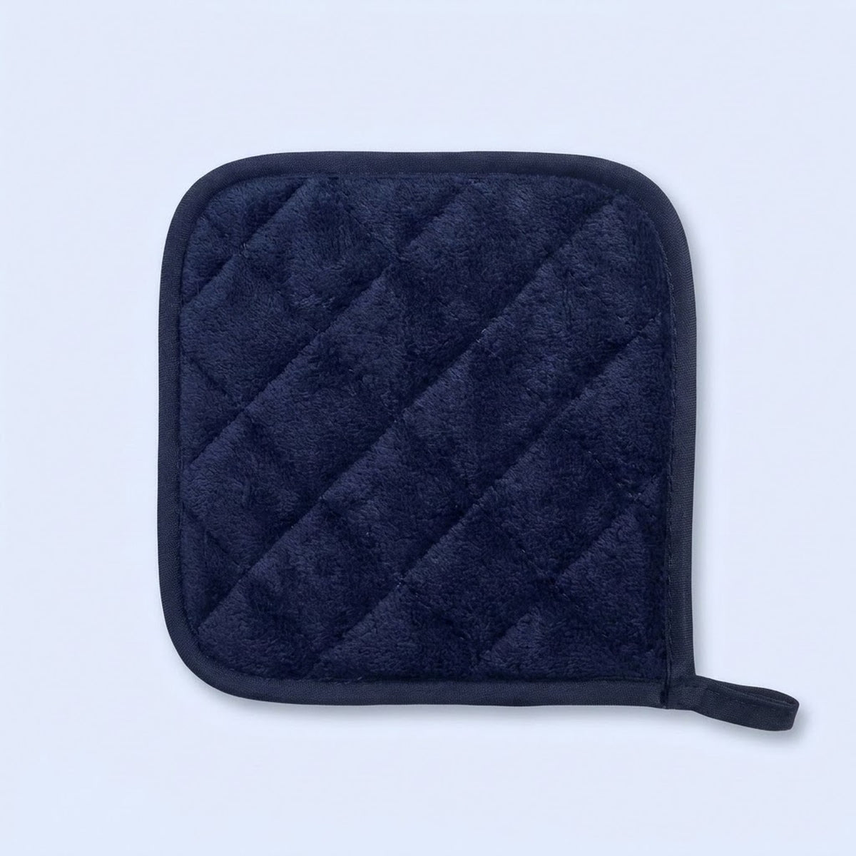 A dark navy blue quilted pot holder with a small loop on the bottom right, shown on a light blue background.