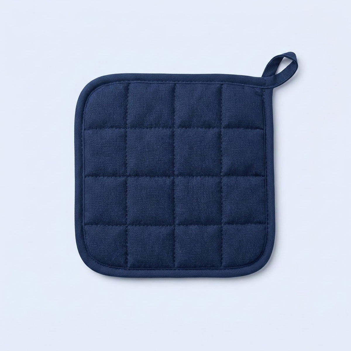 A navy blue quilted pot holder with a small loop handle, shown flat against a light blue background.