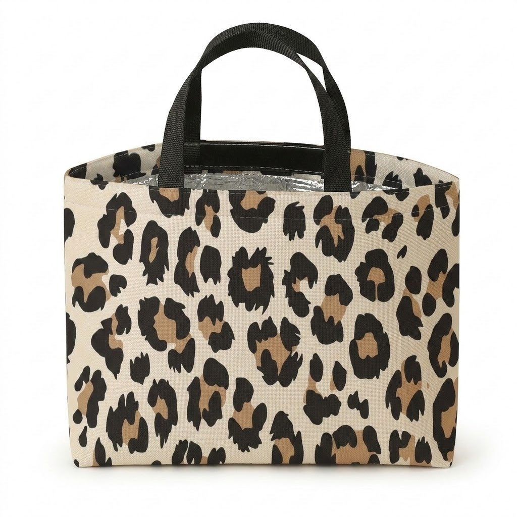 A rectangular tote bag with a beige, brown, and black leopard print pattern and black shoulder straps, shown on a plain white background.