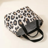 A leopard print insulated tote bag with black handles, shown on a plain off-white background.
