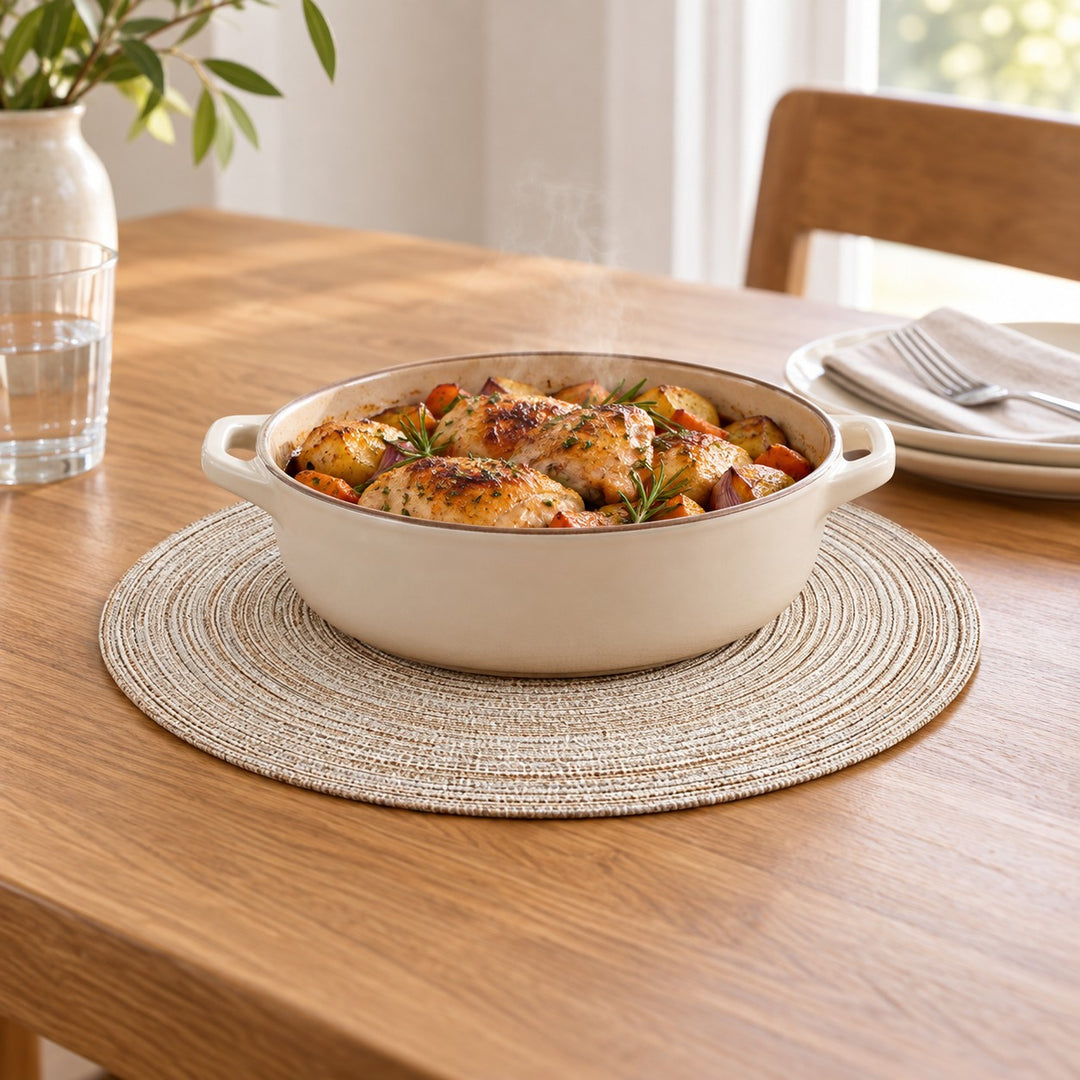 Light beige Round Woven Table Mat beneath a serving dish protects a wooden dining table.