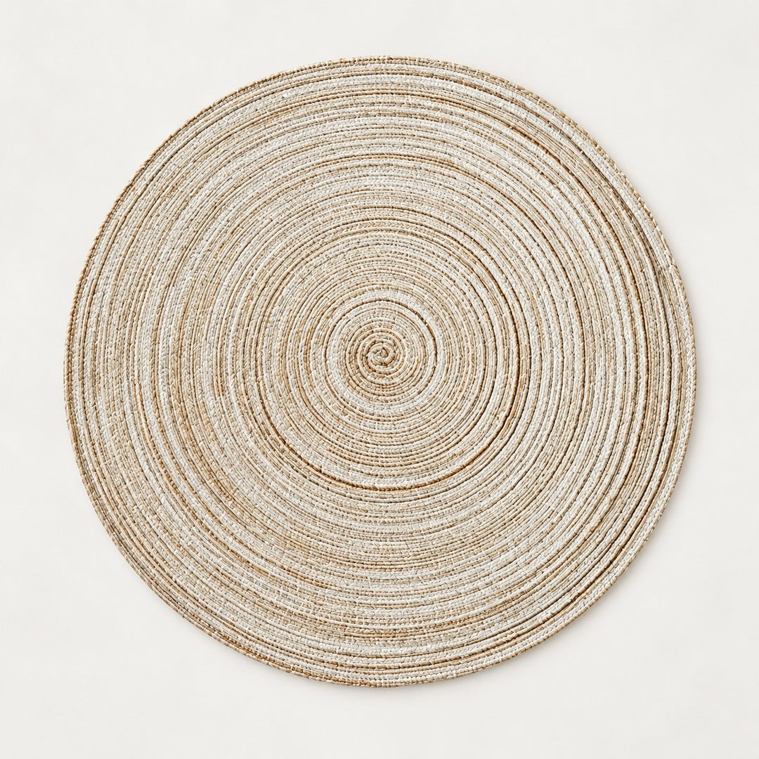 Light beige Round Woven Table Mat displays its tightly coiled, insulating woven construction.