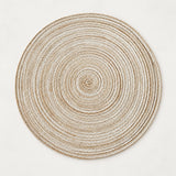 Light beige Round Woven Table Mat displays its tightly coiled, insulating woven construction.