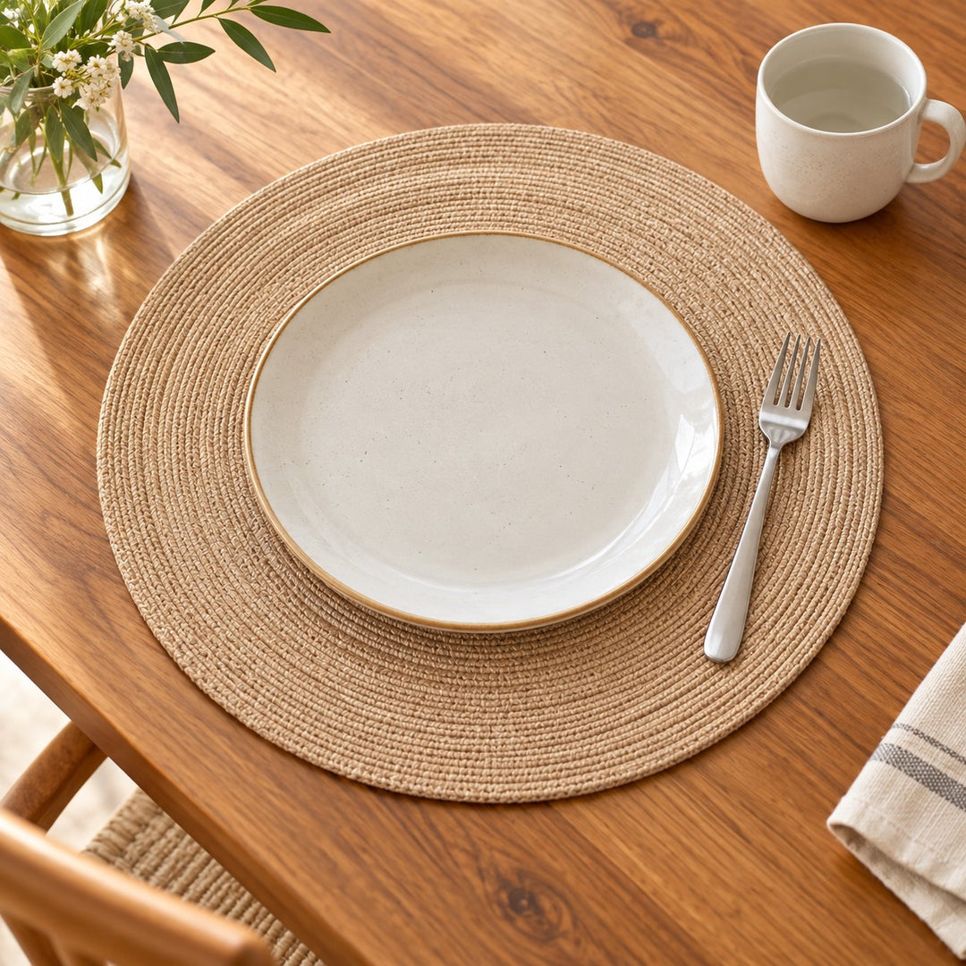 Tan Round Woven Table Mat beneath a dinner plate with a cup and fork for scale.