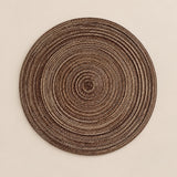 Coffee Brown Round Woven Table Mat centered on a soft brown studio background.