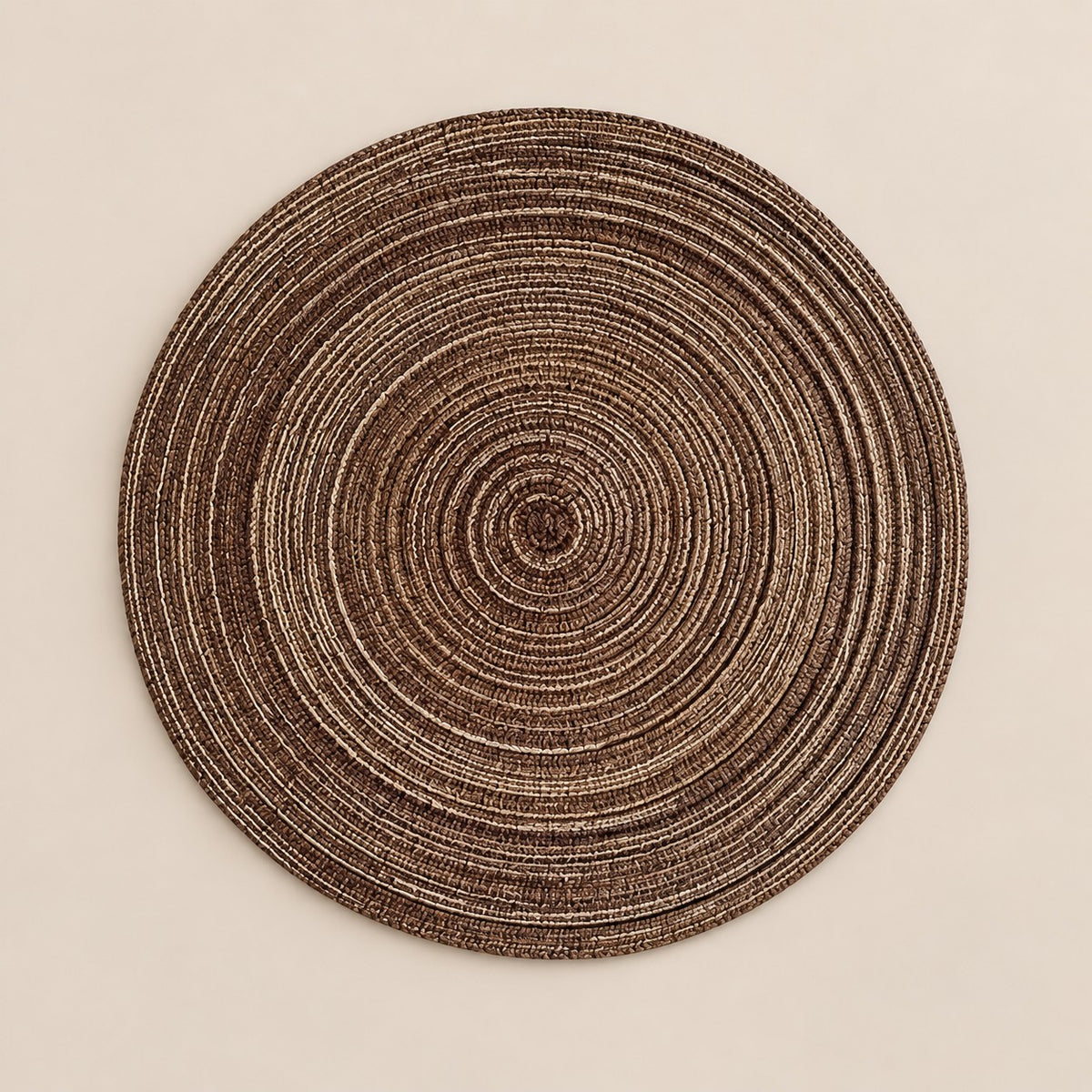 Coffee Brown Round Woven Table Mat centered on a soft brown studio background.