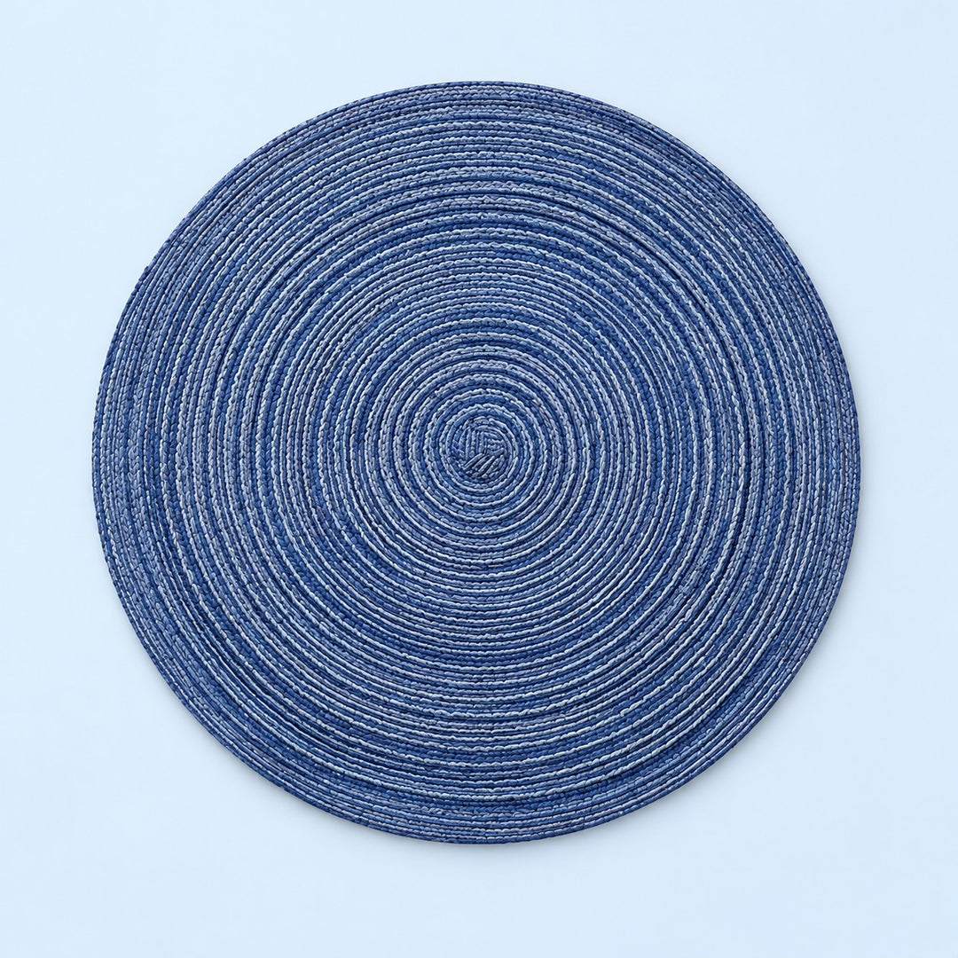 Blue Round Woven Table Mat centered on a pale blue studio background.