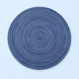 Blue Round Woven Table Mat centered on a pale blue studio background.