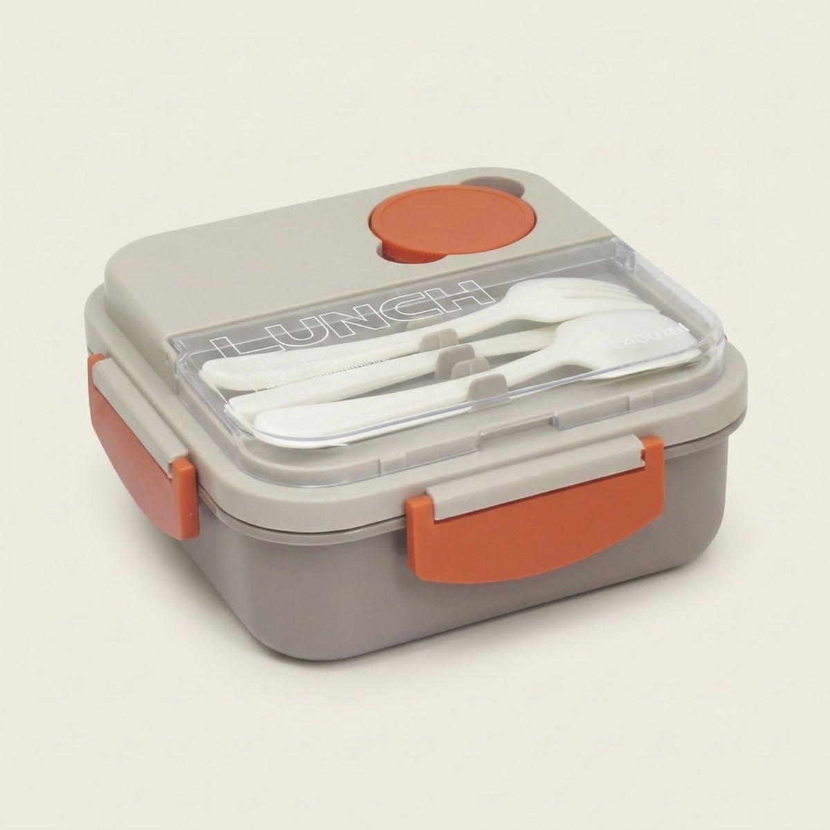 A gray and orange lunch box with a clear lid, containing white plastic cutlery. The lid features a circular orange button and the word 'LUNCH' molded into the clear plastic.
