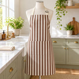 Brown striped kitchen apron shown during household cleaning beside a simple kitchen counter.