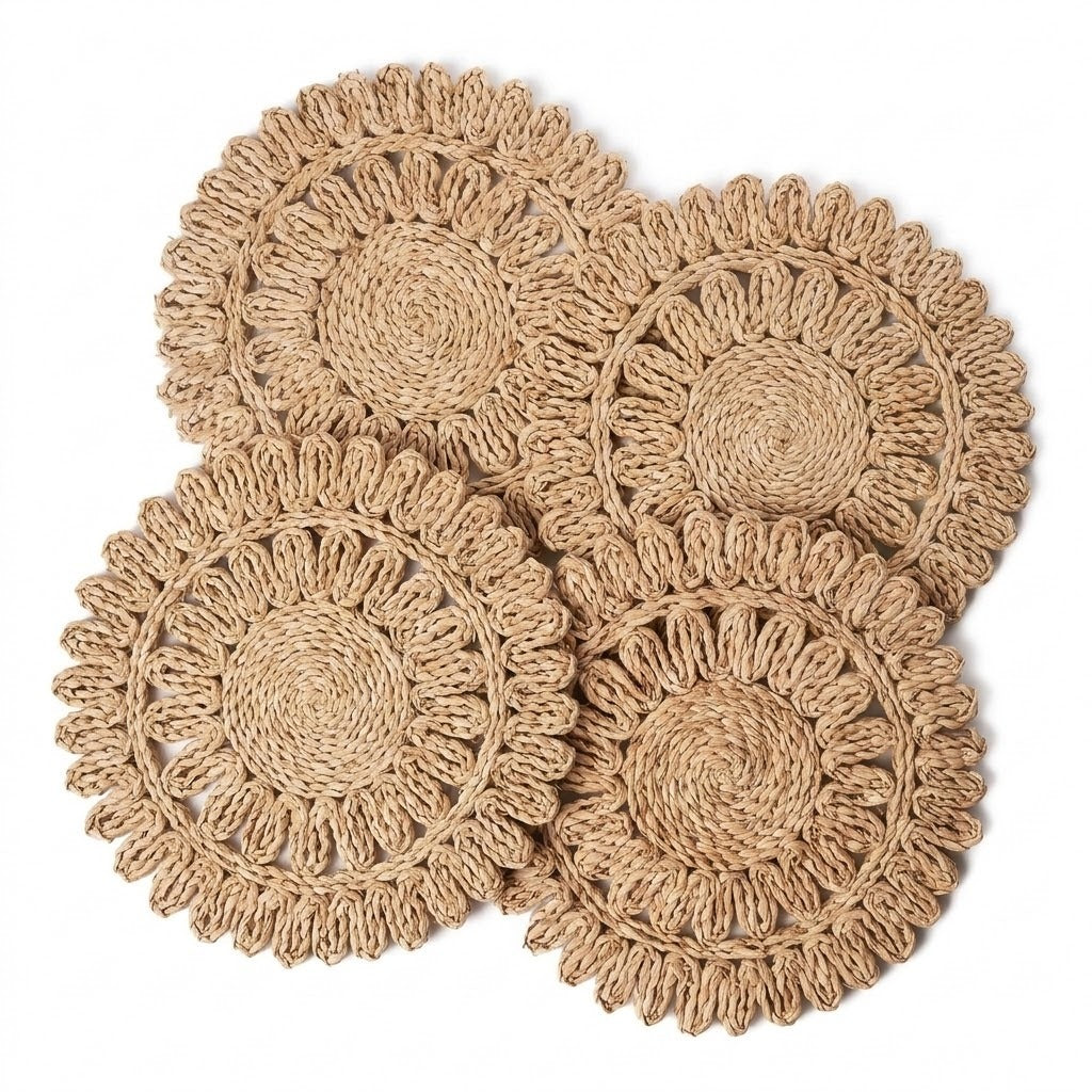 Four round woven seagrass coasters with a scalloped edge, arranged in a overlapping flat-lay composition on a solid white background.