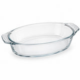One empty oval borosilicate glass baking dish with integrated textured handles on white.