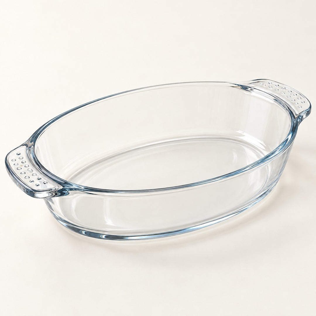 Clear oval glass baking dish highlights its thick curved handles and transparent, glossy finish.