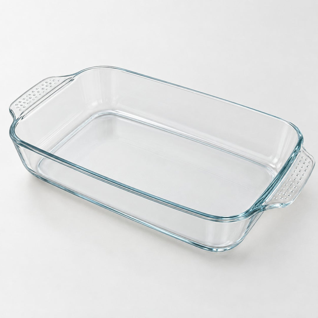 Rectangular clear glass baking dish shown alone on a pale gray studio background.