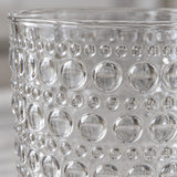 Macro view of the clear embossed dot drinking glass shows its glossy raised glass dots.