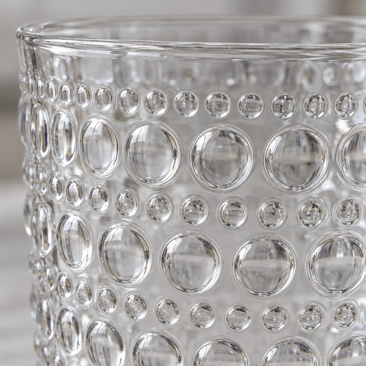 Macro view of the clear embossed dot drinking glass shows its glossy raised glass dots.