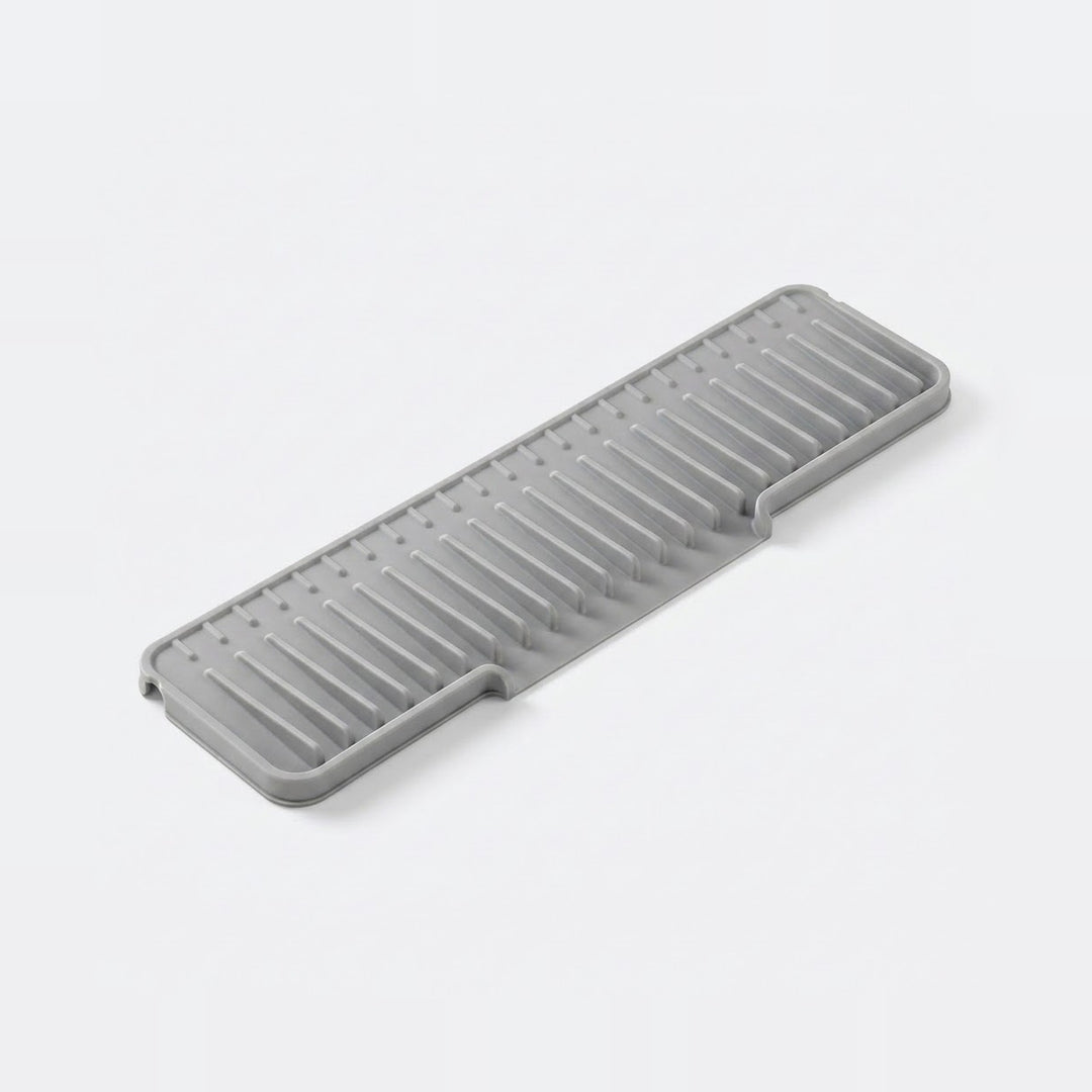 Black plastic tool or component on a white background