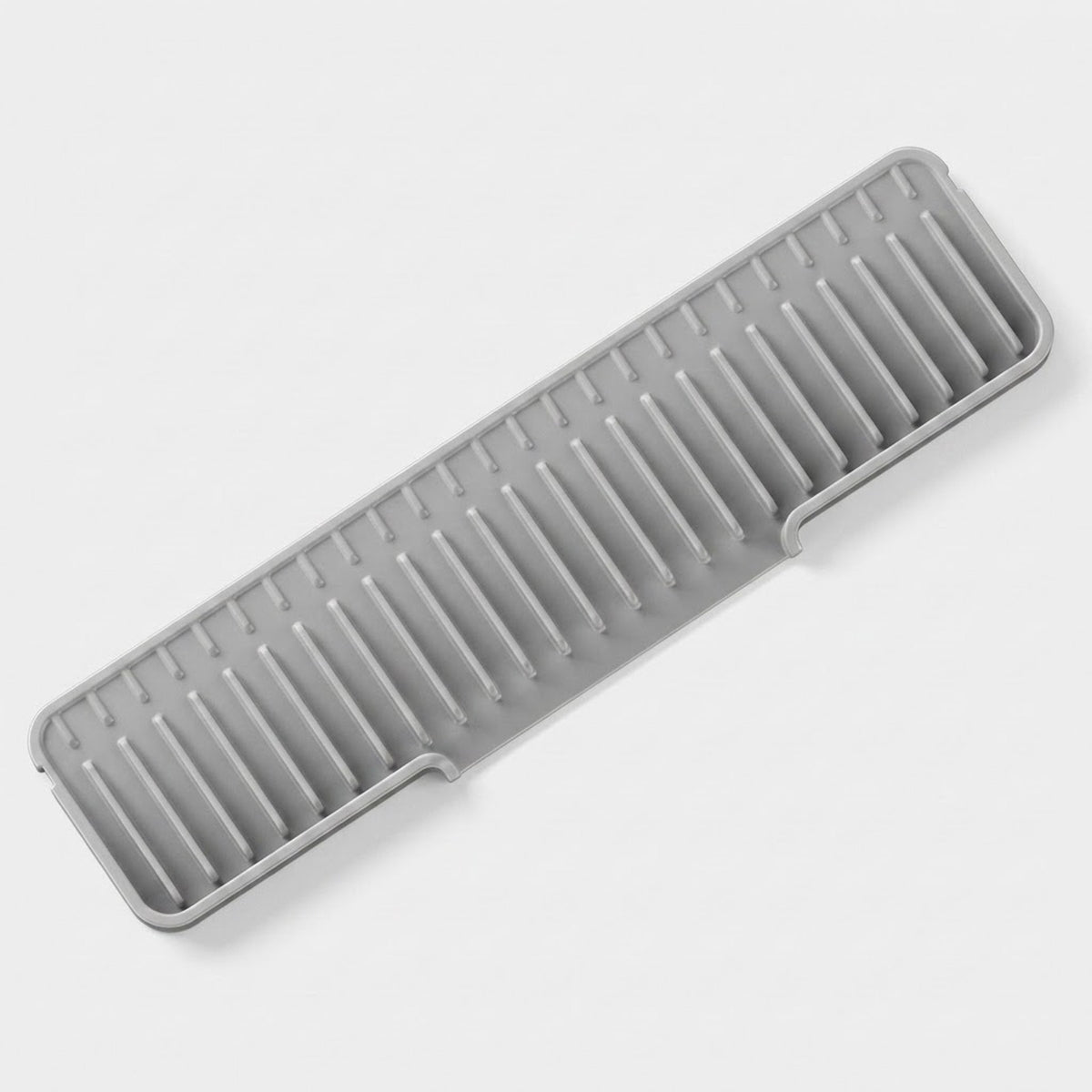A gray plastic kitchen utensil or organizer tray with multiple parallel slots, shown on a clean light gray background.