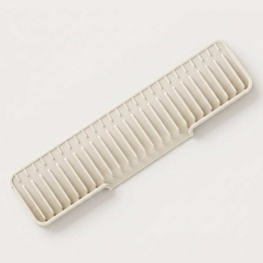 A rectangular plastic dish rack with parallel ridges, shown at an angle on a clean, light off-white background.