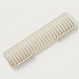 A rectangular plastic dish rack with parallel ridges, shown at an angle on a clean, light off-white background.