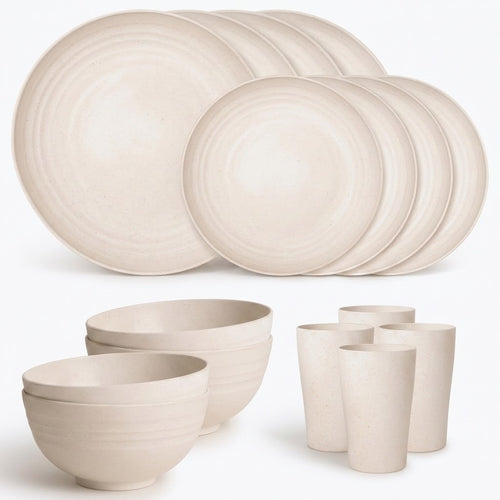 A coordinated ceramic dinnerware set in a warm off-white or cream tone, including multiple round plates, bowls, and cups, arranged on a clean white background.