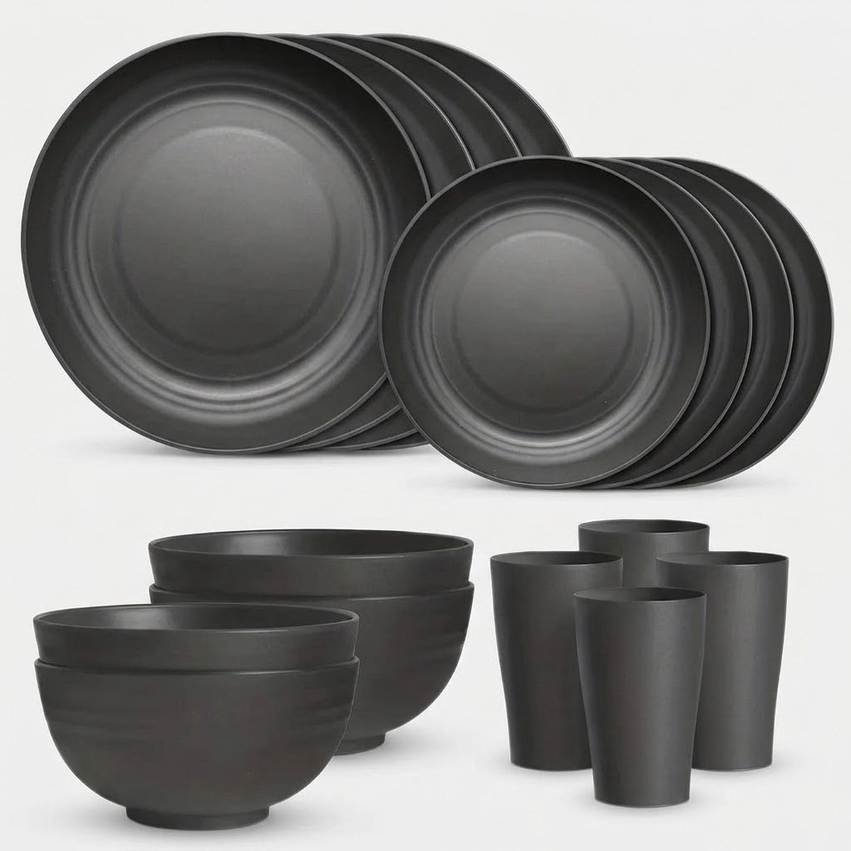 A matte black dinnerware set including plates, bowls, cups, and tumblers, arranged on a light gray background.