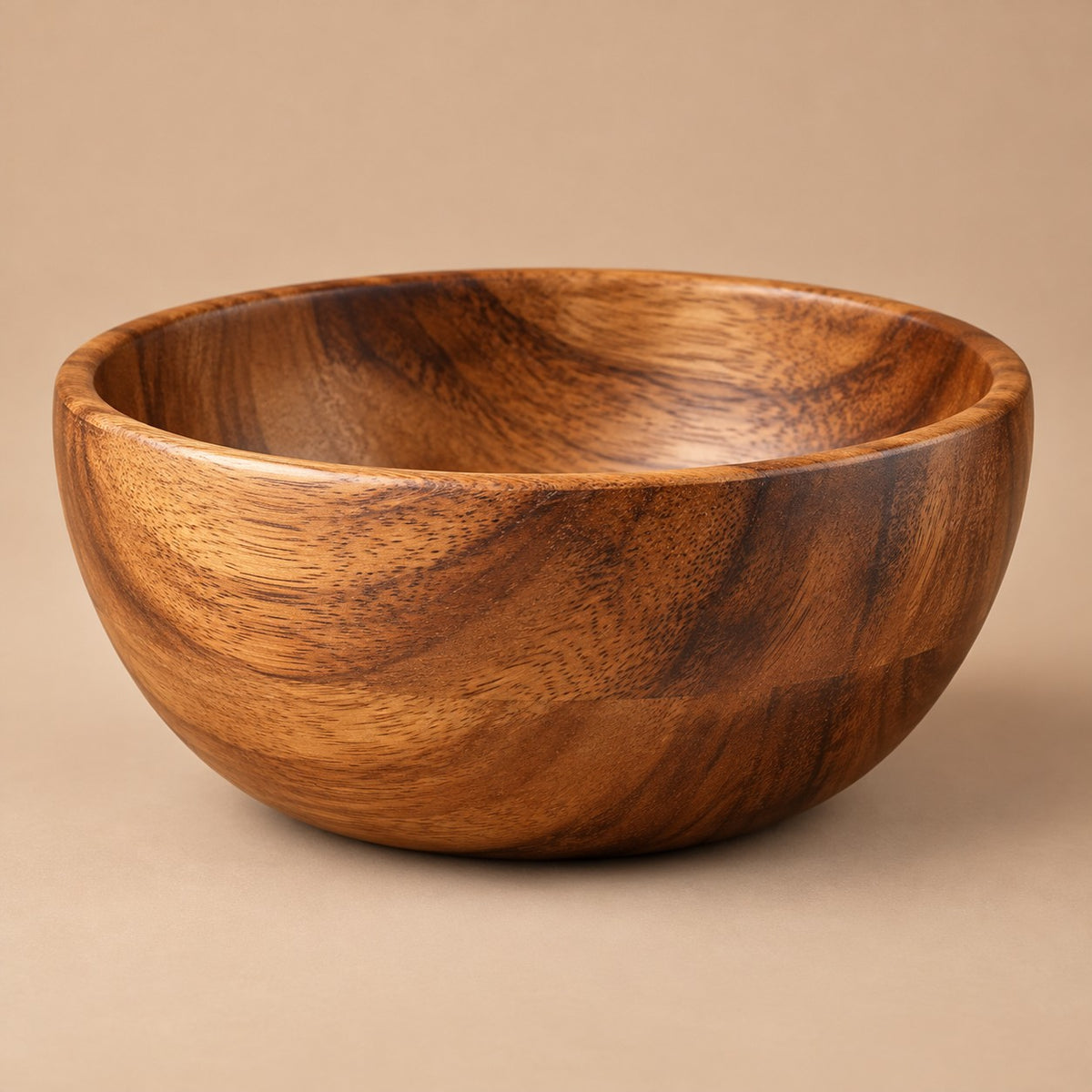 Large 550 ml acacia wood salad bowl centered on a soft brown studio backdrop.