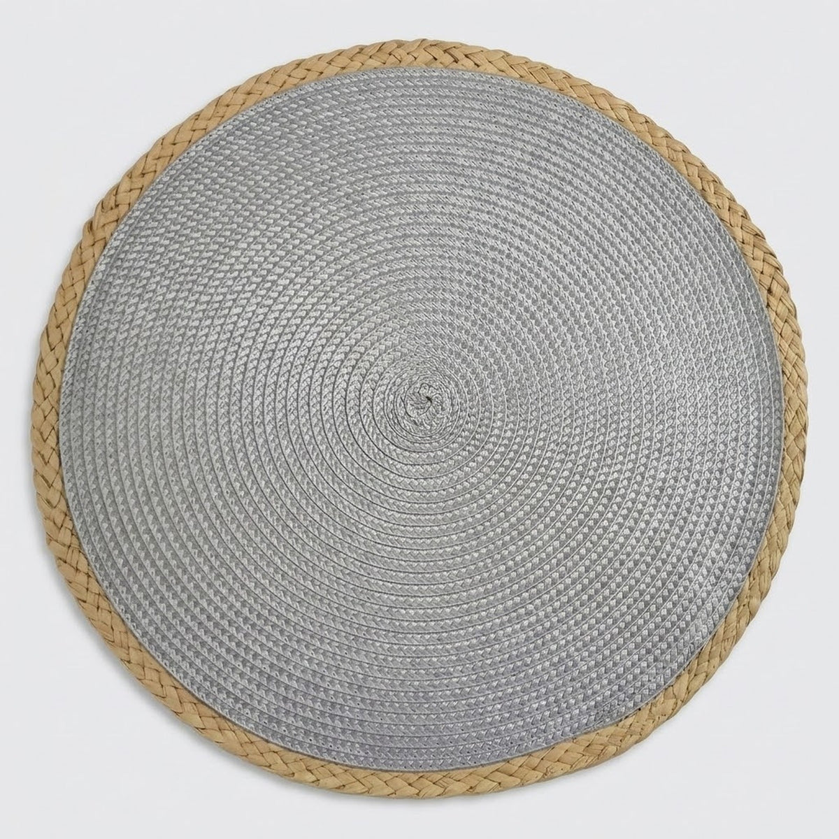 A round woven placemat with a textured silver-gray center and a natural tan braided border, shown flat against a light gray background.