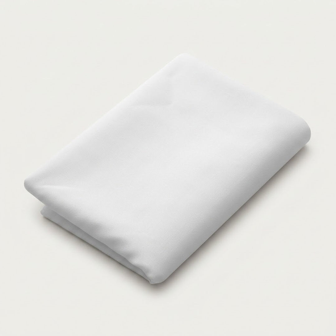 A folded white fabric item, likely a sheet or blanket, shown on a clean, light off-white background.