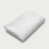 A folded white fabric item, likely a sheet or blanket, shown on a clean, light off-white background.