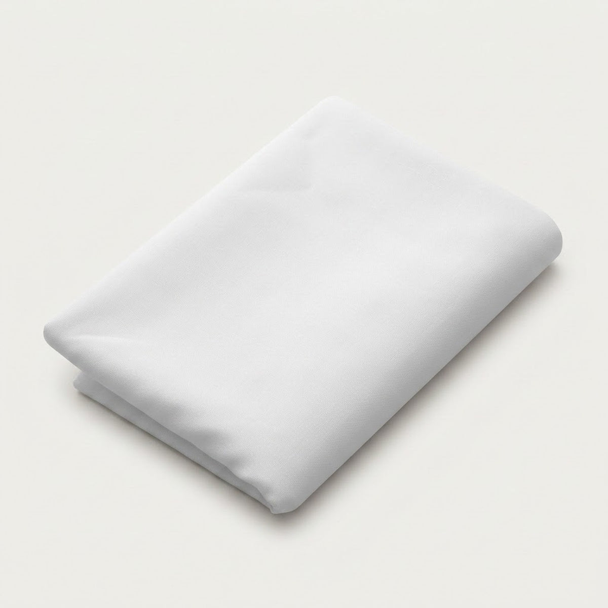 A folded white fabric item, likely a sheet or blanket, shown on a clean, light off-white background.