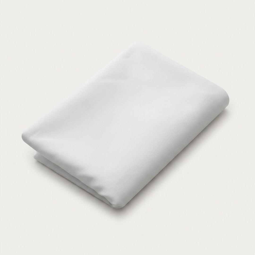 A folded white sheet or pillowcase on a clean, light off-white background.