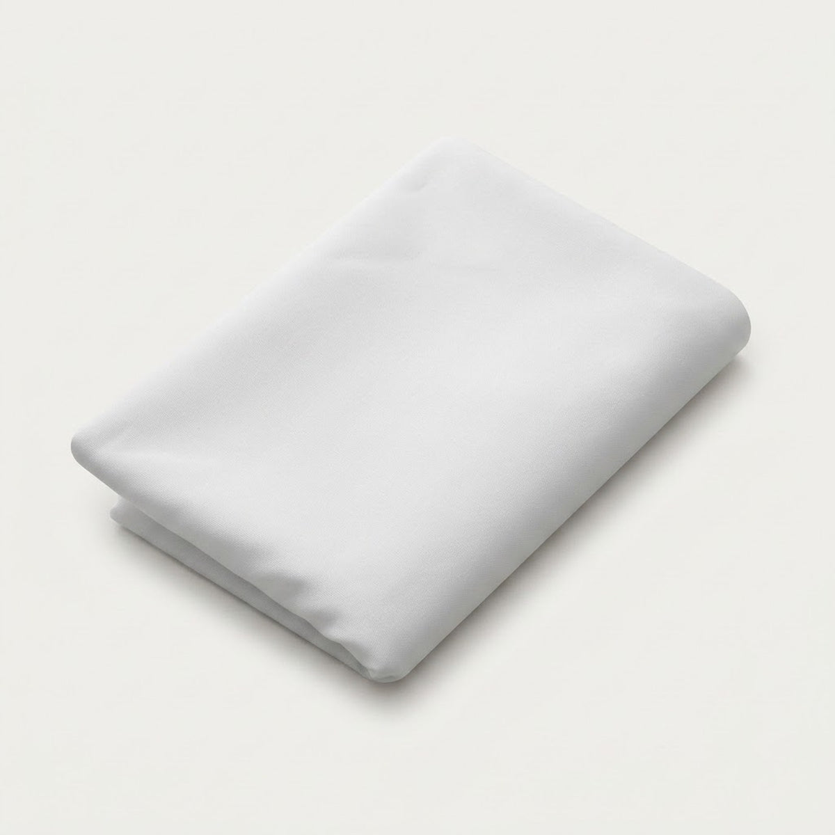 A folded white sheet or pillowcase on a clean, light off-white background.