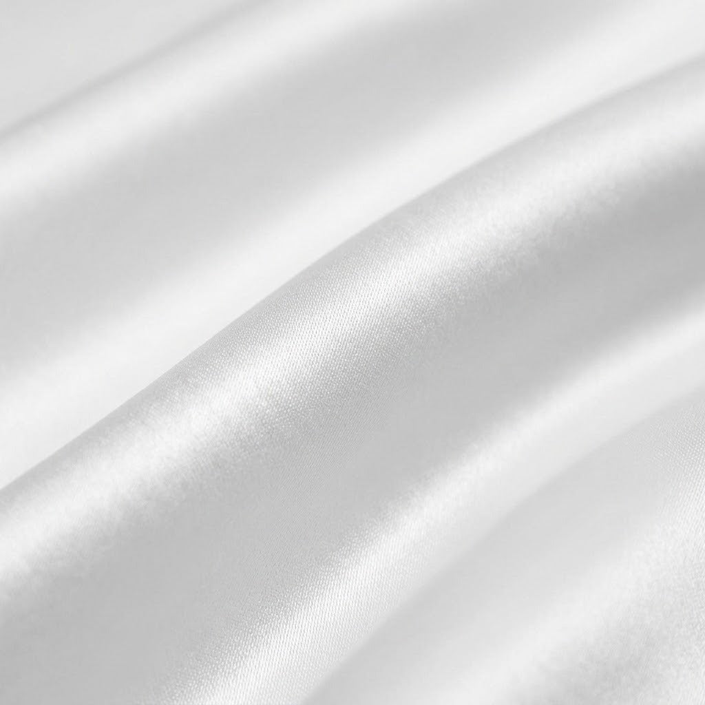 A close-up of draped white satin fabric with soft folds and a subtle sheen.