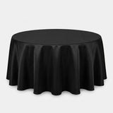 A round black tablecloth draped over a circular table, shown against a plain light gray studio background.