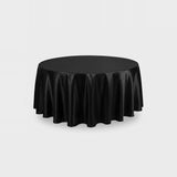 A round black tablecloth draped over a round table, shown against a light gray studio background.