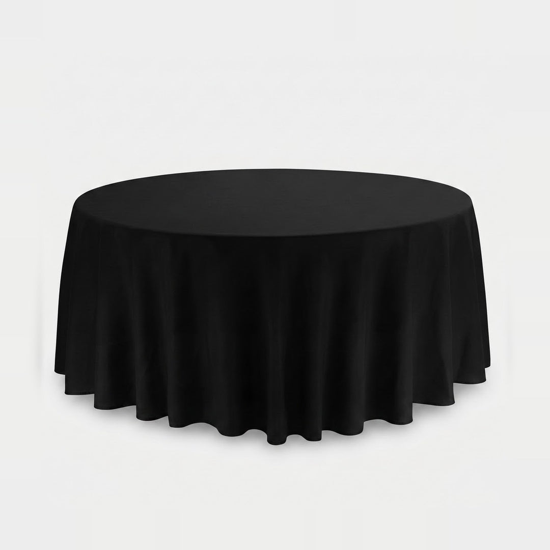 A round black tablecloth draped over a circular table, shown against a plain light gray studio background.