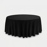 A round black tablecloth draped over a circular table, shown against a plain light gray studio background.