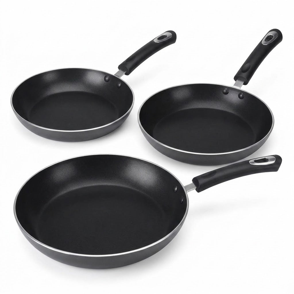 Three black non-stick frying pans of different sizes arranged on a white background.