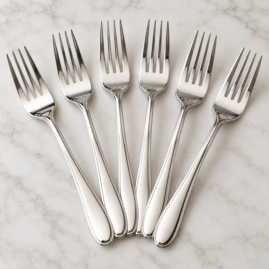 A close hero arrangement shows the bright polished finish of the silver party forks.
